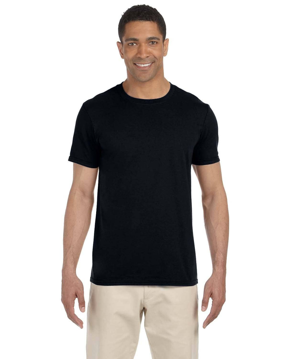 Man wearing a black t-shirt and beige pants on a white background