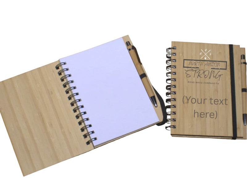 Wooden notebook with pen and personalized text on a white background