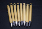 Set of wooden pens with metallic tips on a dark background