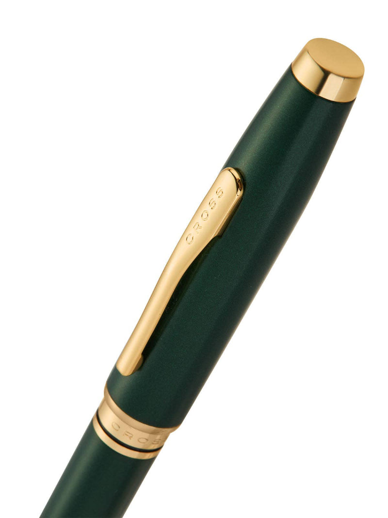 Green pen with gold accents on a white background
