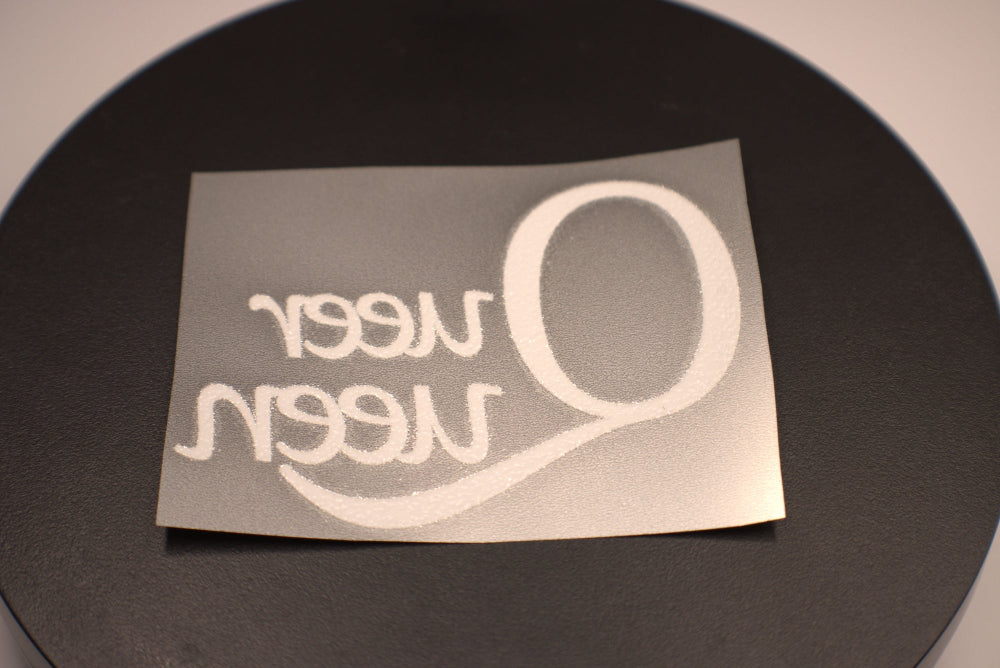 White decal with text on a black background