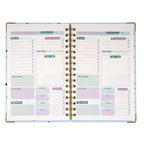 Open planner with daily schedule and to-do list on a white background