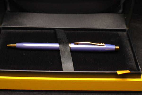 Purple pen with gold accents in a black and gold case