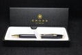 Pen set with a Cross logo in a black box on a black background
