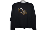 Black sweatshirt with 'Queer Queen' text in gold on a white background