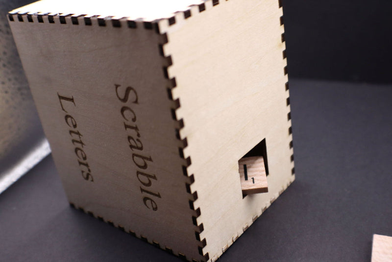 Wooden Scrabble letter holder on a dark surface